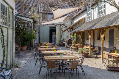 Tables and chairs at sidewalk cafe