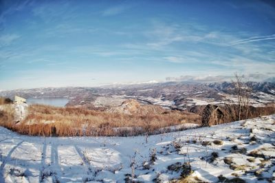 Scenic view of snowcapped mountains against sky