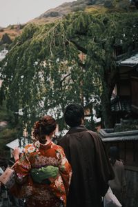 Rear view of people walking outdoors