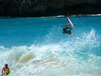 People surfing in sea