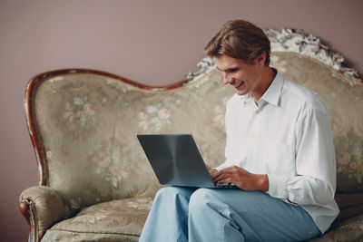 Young woman using laptop at home