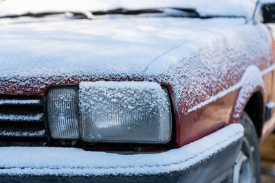 Close-up of icicles on snow covered car