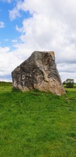 Scenic view of rocks on field against sky