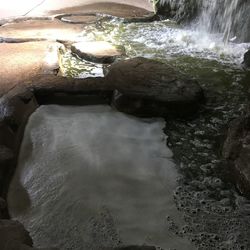 High angle view of river flowing through rocks