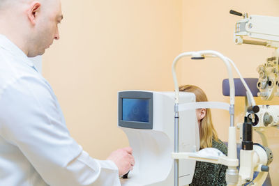 Doctor examining patient in clinic