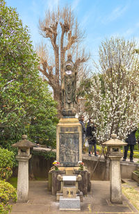 Statue in park against sky