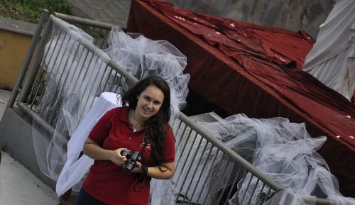 Portrait of woman holding camera