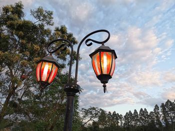 Low angle view of illuminated street light against sky