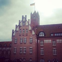 Low angle view of clock tower against sky