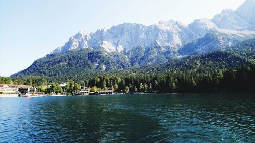 Scenic view of lake and mountains against clear sky