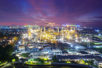 High angle view of illuminated cityscape against sky at dusk