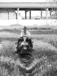 Rear view of woman standing on field