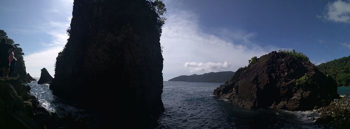 Panoramic view of sea and mountains against sky