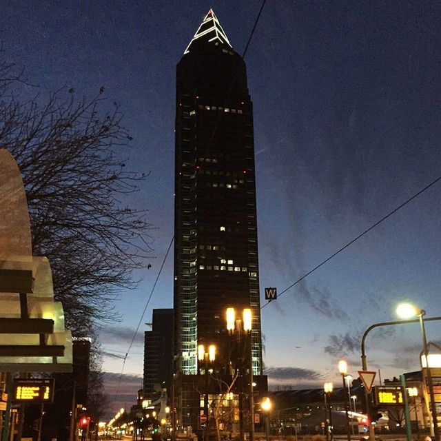 building exterior, architecture, illuminated, built structure, city, night, low angle view, skyscraper, tower, tall - high, modern, sky, street light, office building, city life, building, lighting equipment, dusk, outdoors, no people