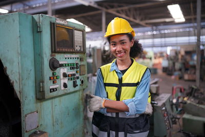 Portrait of young man working in factory