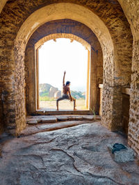 Rear view of woman standing on archway