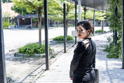 Woman in a black dress holds a laptop computer. the concept of young entrepreneurs.