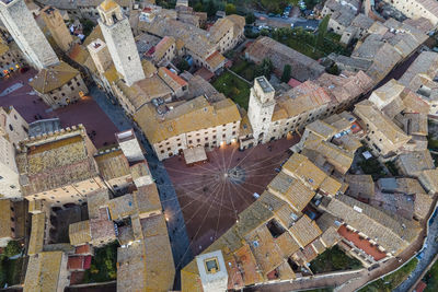 Aerial view of san gimignano town square with christmas lights at sunset, siena, tuscany, italy.