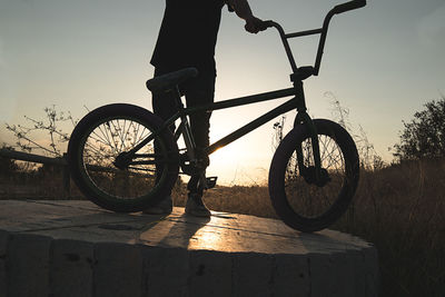 Bicycle parked by railing against clear sky