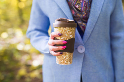 Midsection of woman holding ice cream