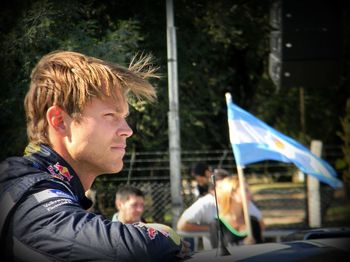 Side view portrait of two people looking away outdoors