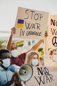 Diverse women in masks with loudspeaker during the no to war demonstration. war ukraine russia