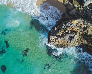 High angle view of rocks in sea