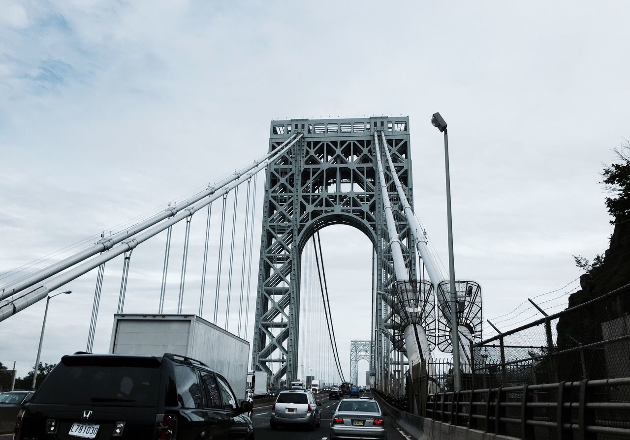 engineering, transportation, bridge - man made structure, connection, car, built structure, architecture, suspension bridge, mode of transport, travel, sky, low angle view, land vehicle, outdoors, travel destinations, day, cloud - sky, bridge, no people, city