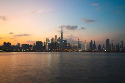 City at waterfront during sunset