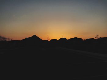 Silhouette landscape against clear sky during sunset