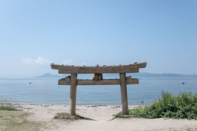 Lifeguard hut on beach against sky
