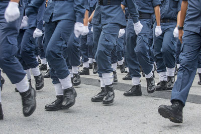 Low section of people walking on tiled floor