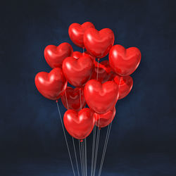 Close-up of red balloons against black background