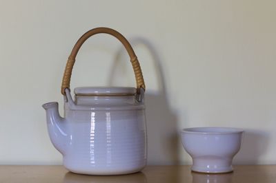 Close-up of teapot and cup on table