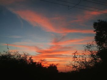 Low angle view of silhouette trees against sky at sunset