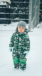 Portrait of cute boy in snow covered field