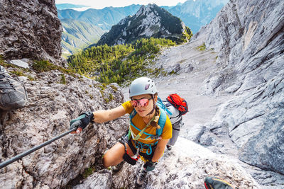 Rear view of man climbing on mountain