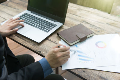 High angle view of man using laptop on table