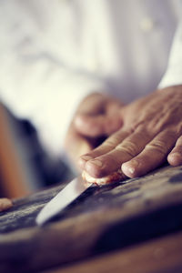 Close-up of hand cutting shrimp