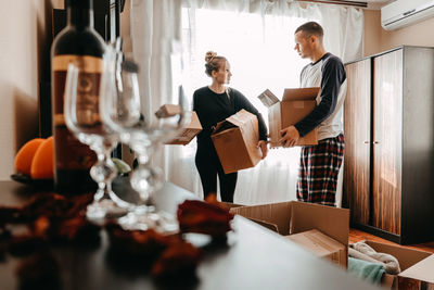 Moving day, new home, unpacking boxes. happy couple in their new apartment is having fun 