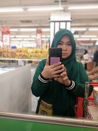 Portrait of young woman using mobile phone