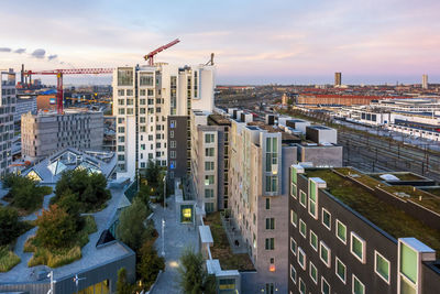 High angle view of buildings in city against sky during sunset