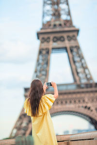 Low angle view of woman using mobile phone