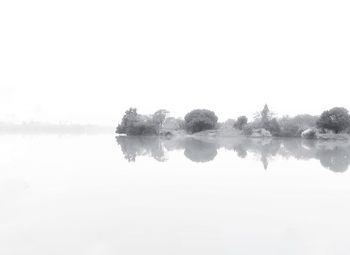 Scenic view of lake against sky during winter