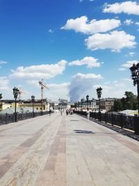 People on street in city against sky