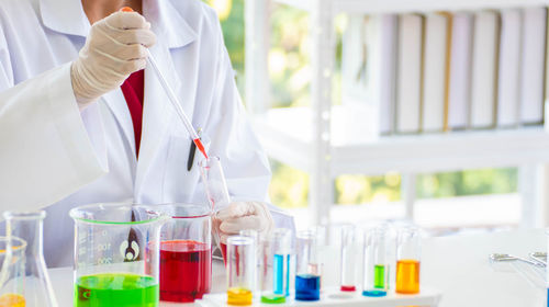 Cropped hand of scientist testing chemicals in laboratory