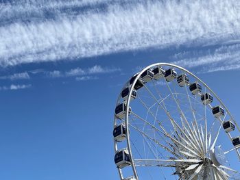 Low angle view of ferris wheel against sky