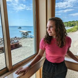 Portrait of young woman standing at beach