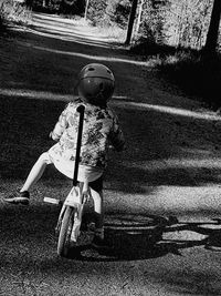 Boy riding motorcycle on road