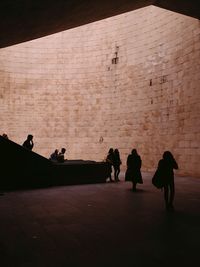 Silhouette people walking at underground walkway